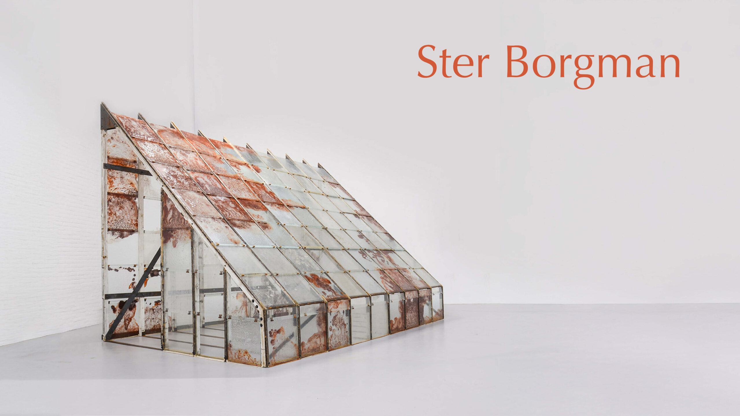 A glass greenhouse with rust glass Art panels.